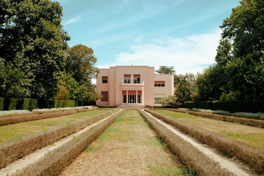 white concrete building near green trees during daytime