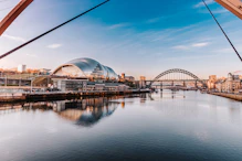white and brown building near body of water during daytime
