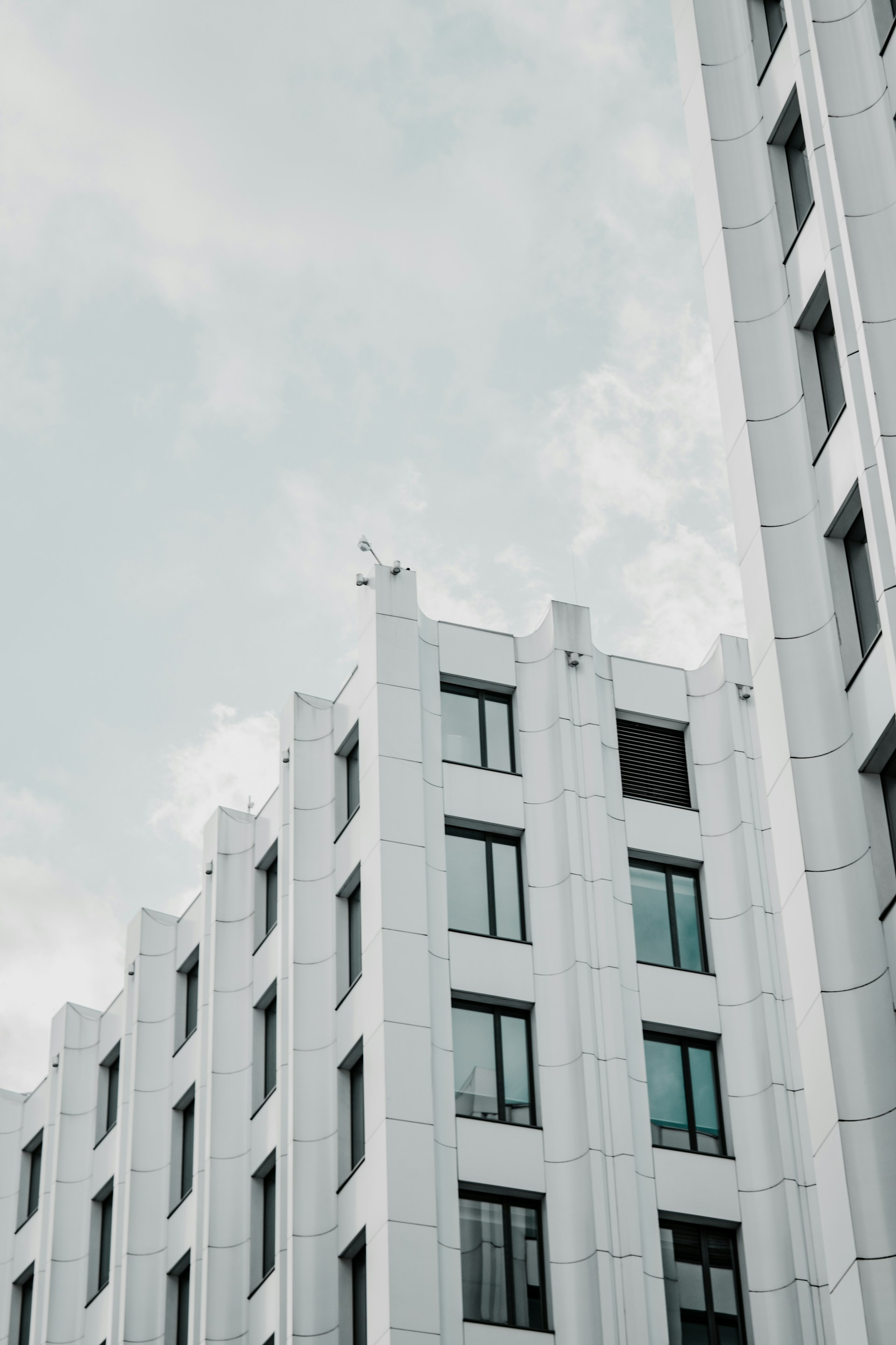 white concrete building under white sky during daytime