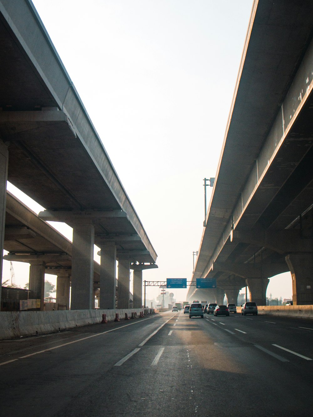 gray concrete bridge under white sky during daytime