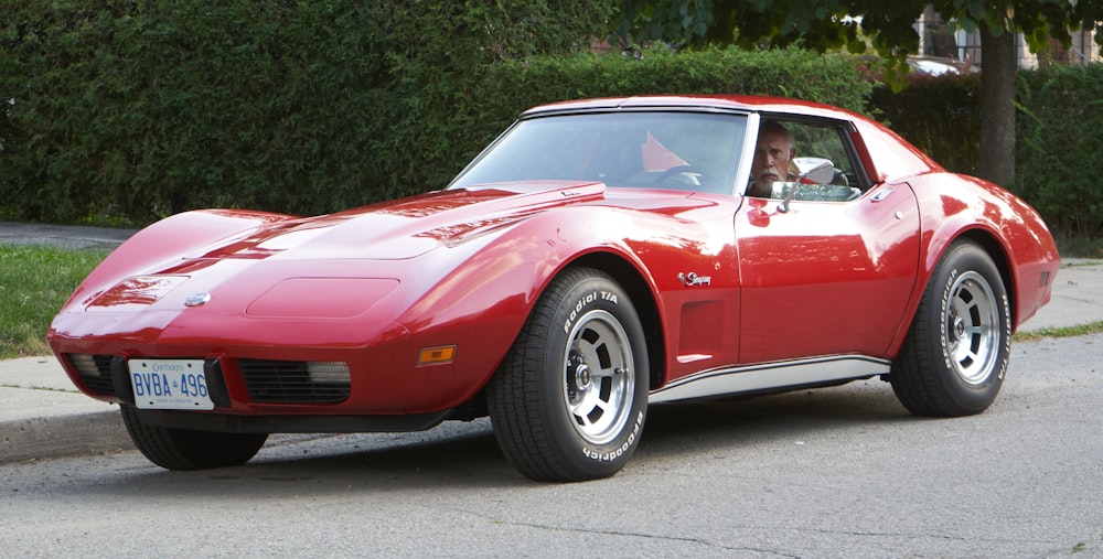 red chevrolet camaro on road during daytime