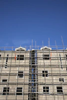 Wide shot of scaffolding surrounding a multi-story building under construction