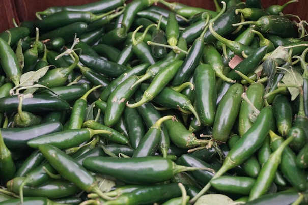 green chili peppers on red plastic container