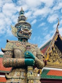 gold and blue dragon statue under blue sky during daytime