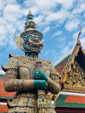 gold and blue dragon statue under blue sky during daytime