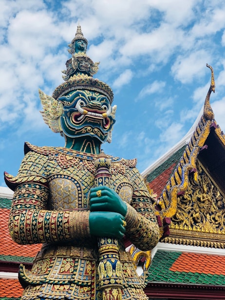 gold and blue dragon statue under blue sky during daytime