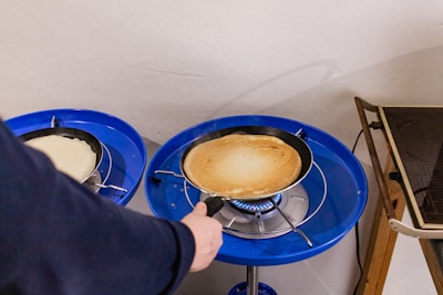 A passionate instructor demonstrating crepe making to attentive students in a bright kitchen.