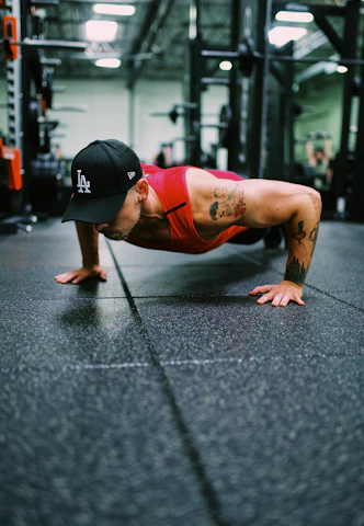 Athlete pushing through a high-intensity workout in a sleek, modern gym setting with black and red accents.