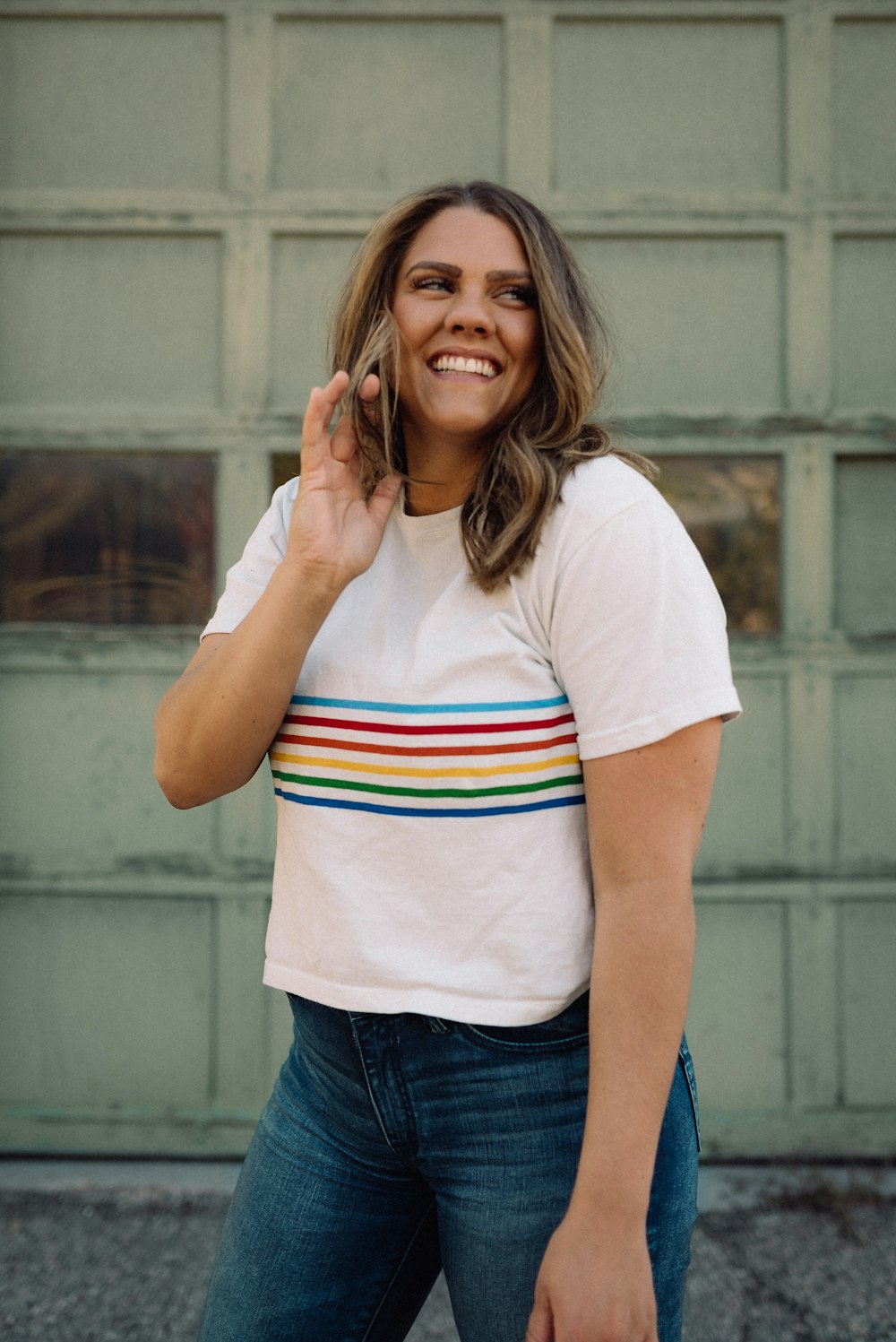 woman in white red and blue crew neck t-shirt and blue denim jeans