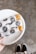 A satisfied customer holding a plate of pastries.
