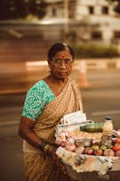 woman in blue and white floral dress holding white ceramic bowl