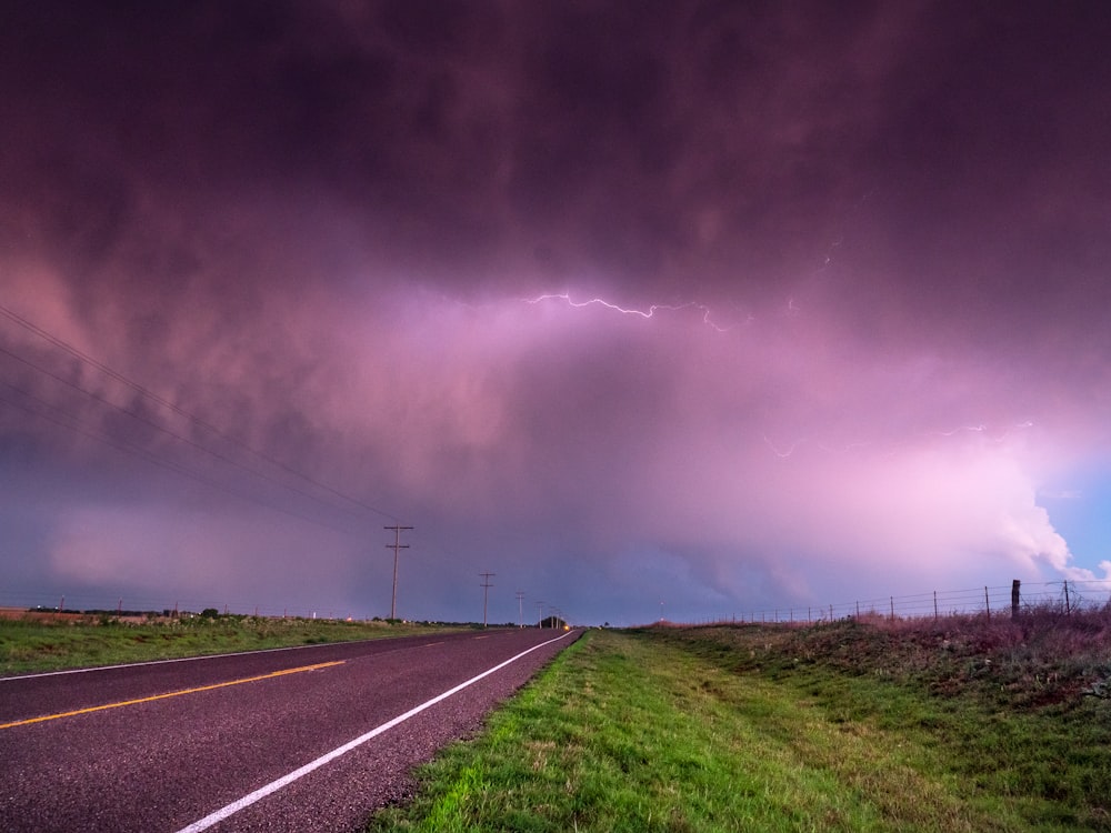 gray concrete road under gray clouds