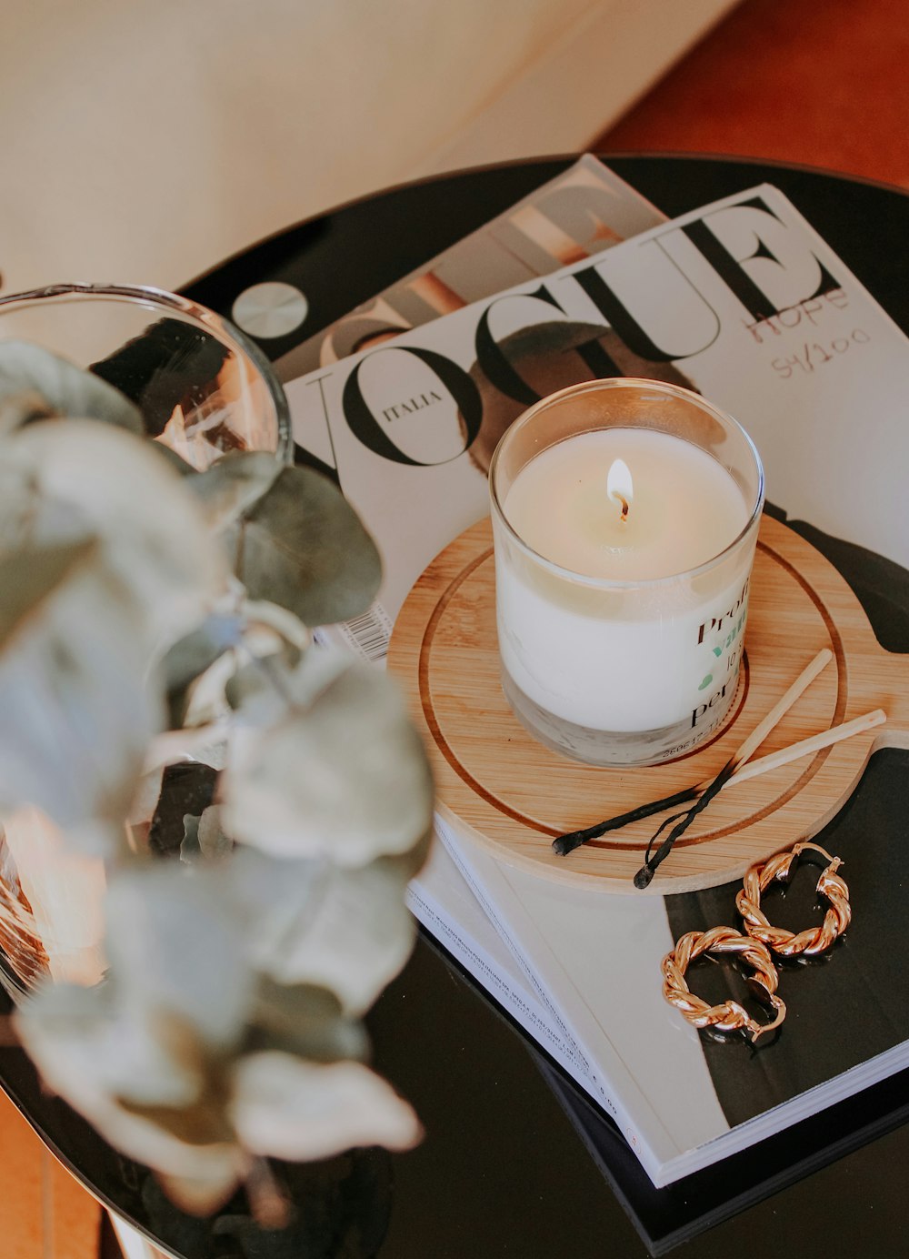 white pillar candle on clear glass holder