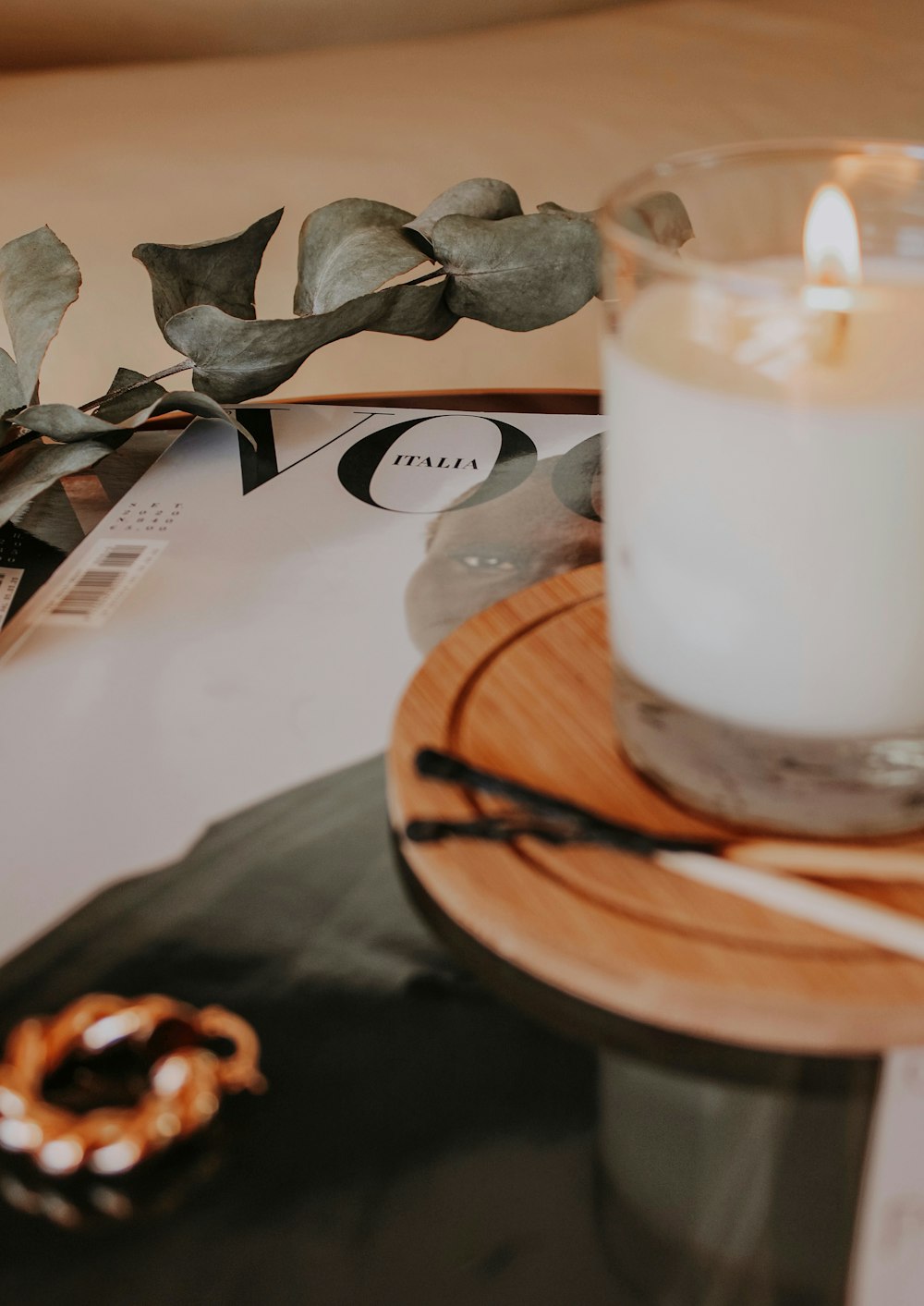 white pillar candle on brown wooden round plate