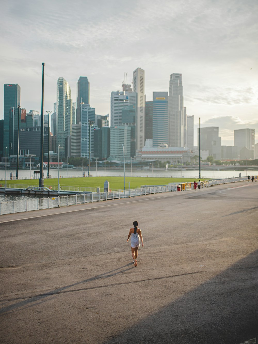 man in black shirt and shorts running on road during daytime