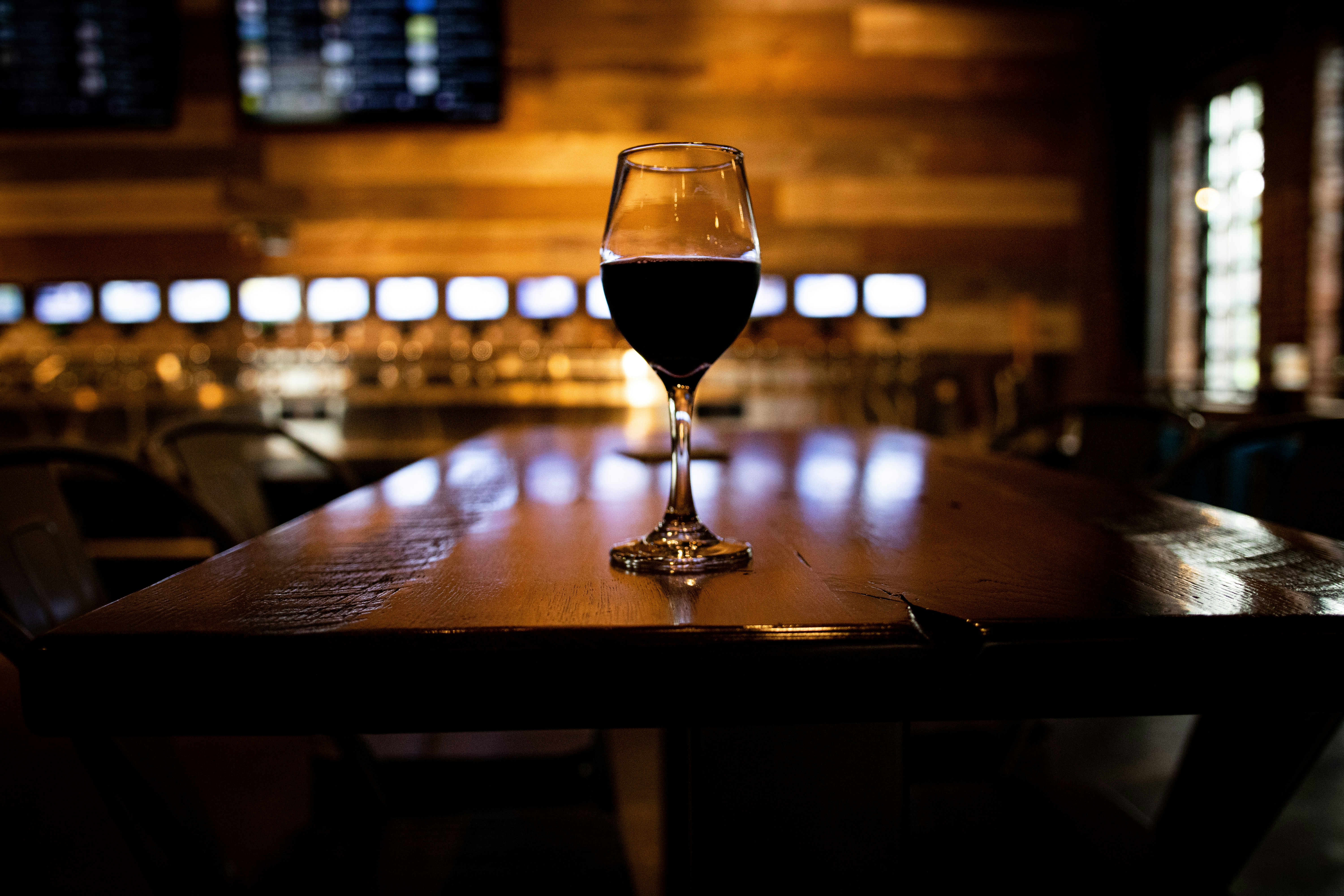 clear wine glass on brown wooden table