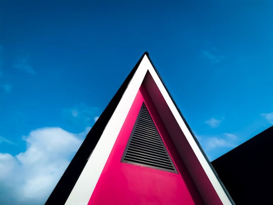 red and black concrete building under blue sky during daytime in Lampung Indonesia
