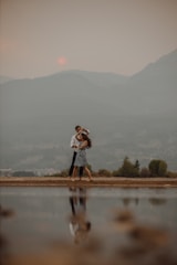 Couple sharing a quiet moment by a mountain lake.