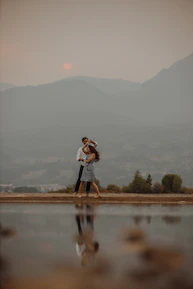 An intimate engagement photo session by a lakeside during golden hour.