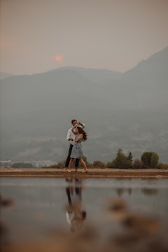 Couple sharing a quiet moment by a mountain lake.
