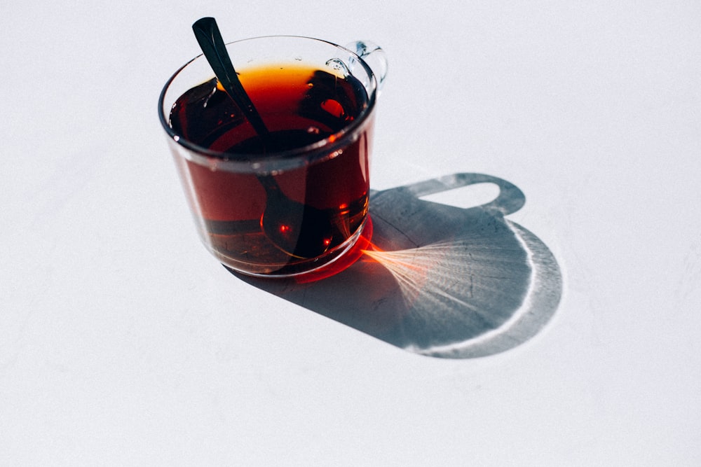 clear glass cup with red liquid