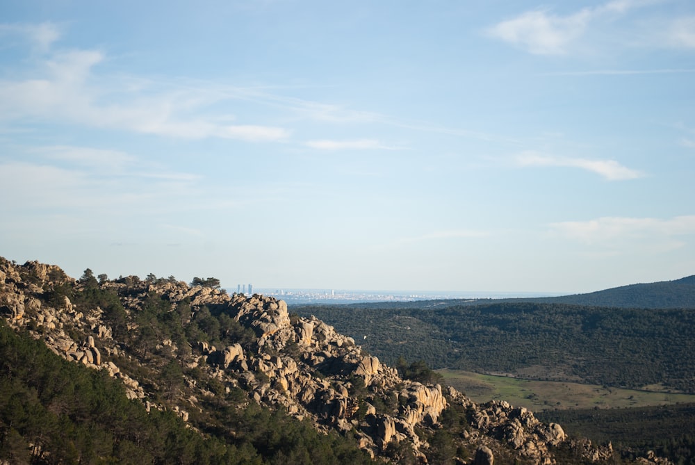 green and brown mountain near body of water during daytime