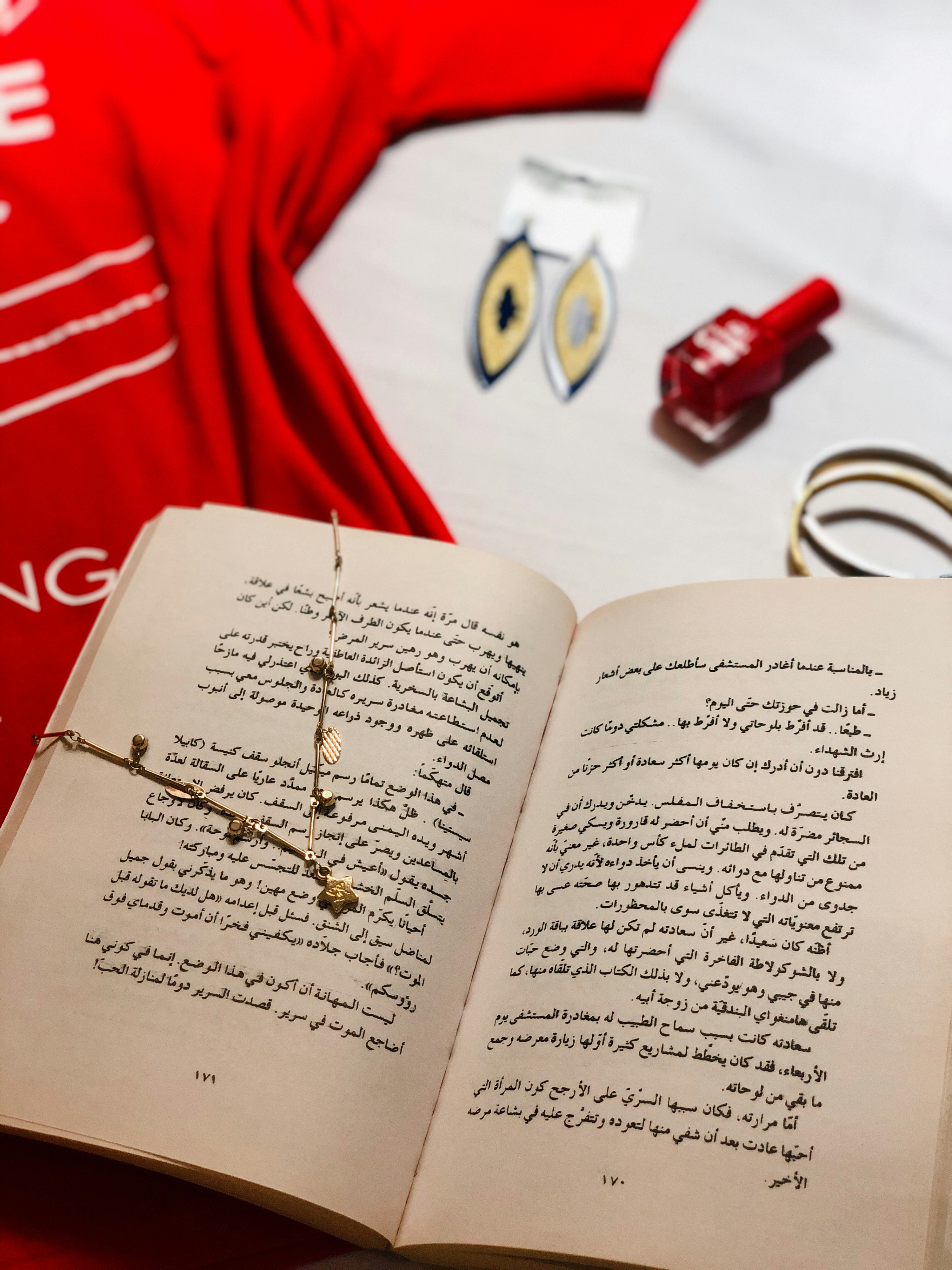 white book page with gold and silver beaded bracelet