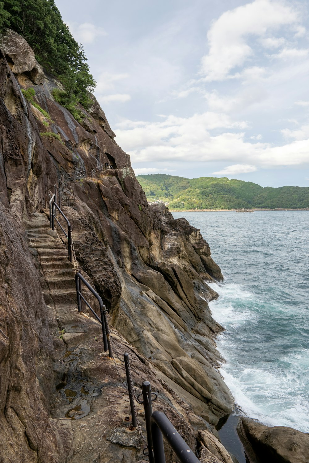 brown rock formation near body of water during daytime