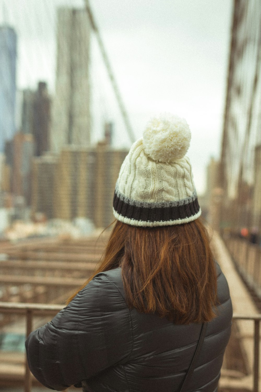 woman in black jacket and white knit cap