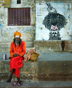 2 men sitting on brown concrete bench