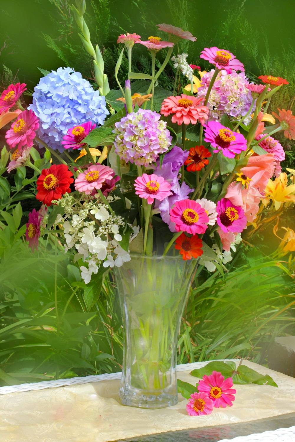 pink and white flowers in clear glass vase