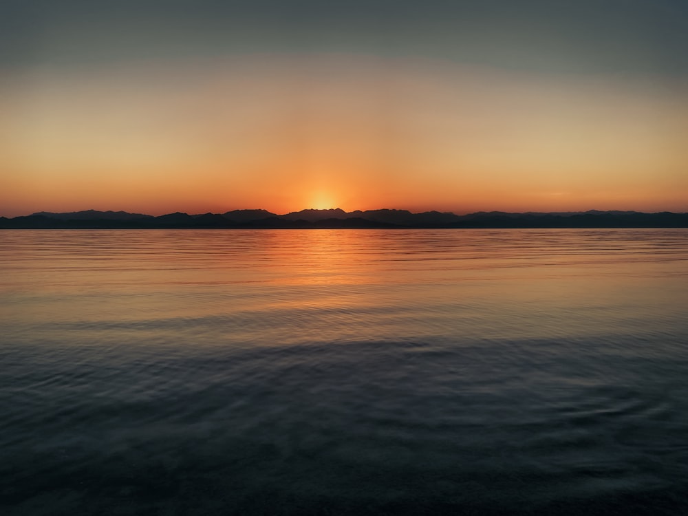 body of water during sunset