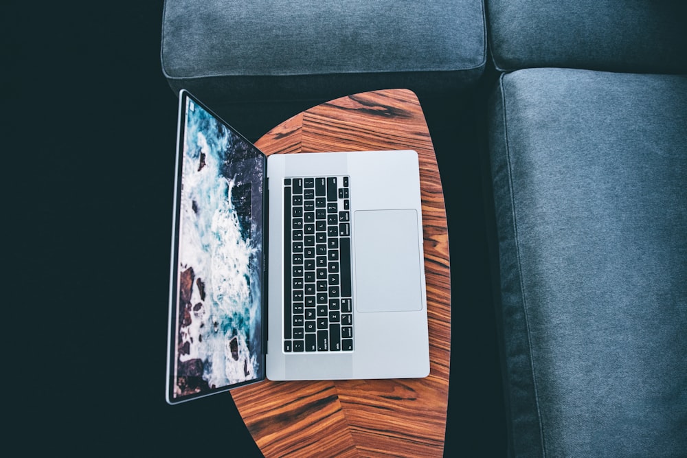 macbook pro on blue and brown chair