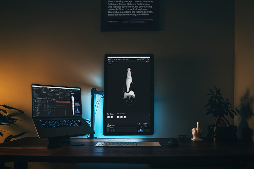 black computer monitor turned on on brown wooden desk