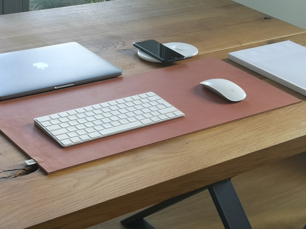 silver macbook on brown wooden table