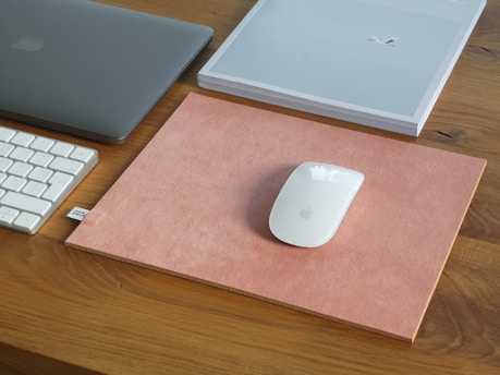 silver macbook on brown wooden table