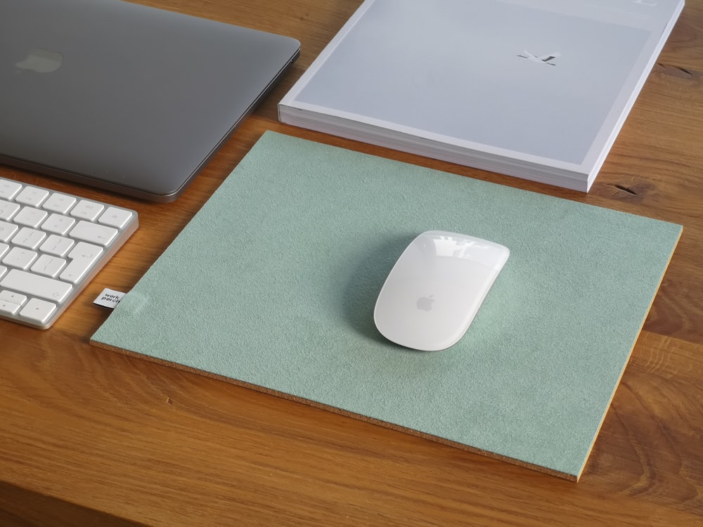 silver macbook on green table