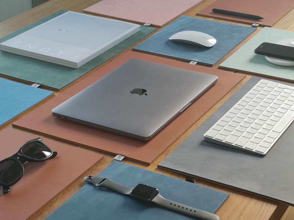 silver macbook on brown wooden table