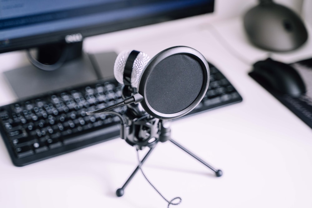 black and silver microphone beside black computer keyboard