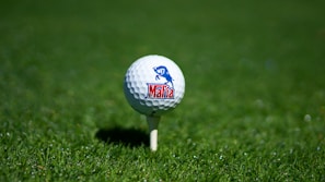 white golf ball on green grass field during daytime
