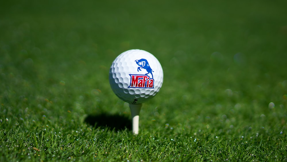 white golf ball on green grass field during daytime