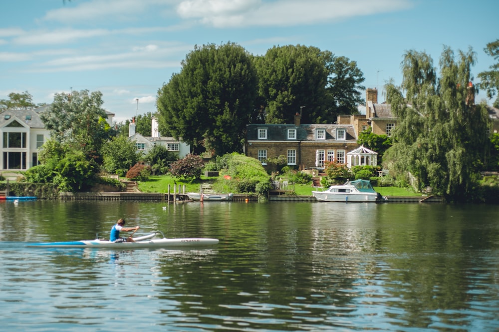 2 people riding on blue kayak on lake during daytime