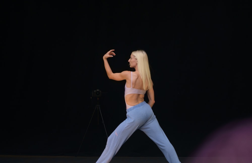 woman in white tank top and blue denim jeans