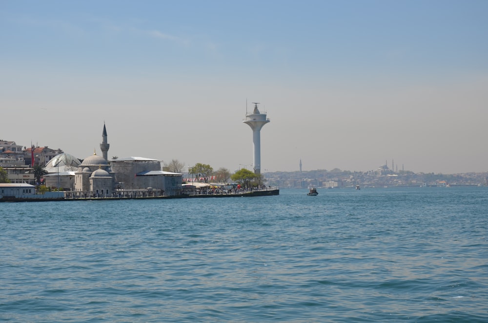 white tower near body of water during daytime