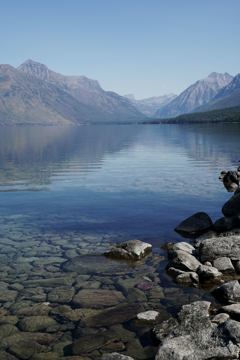 gray rocks near body of water during daytime