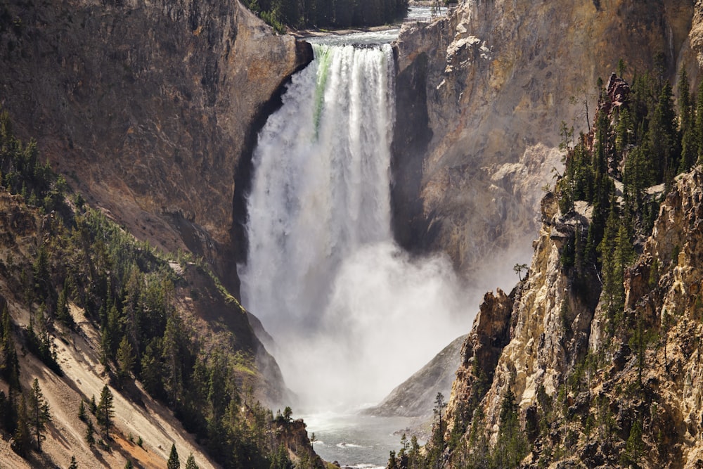 waterfalls in brown rocky mountain during daytime