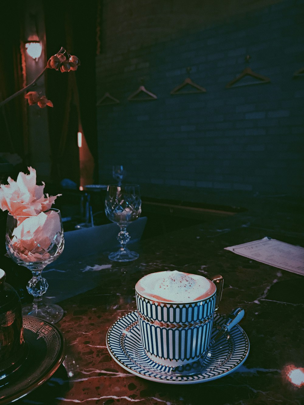 white and black ceramic mug on table