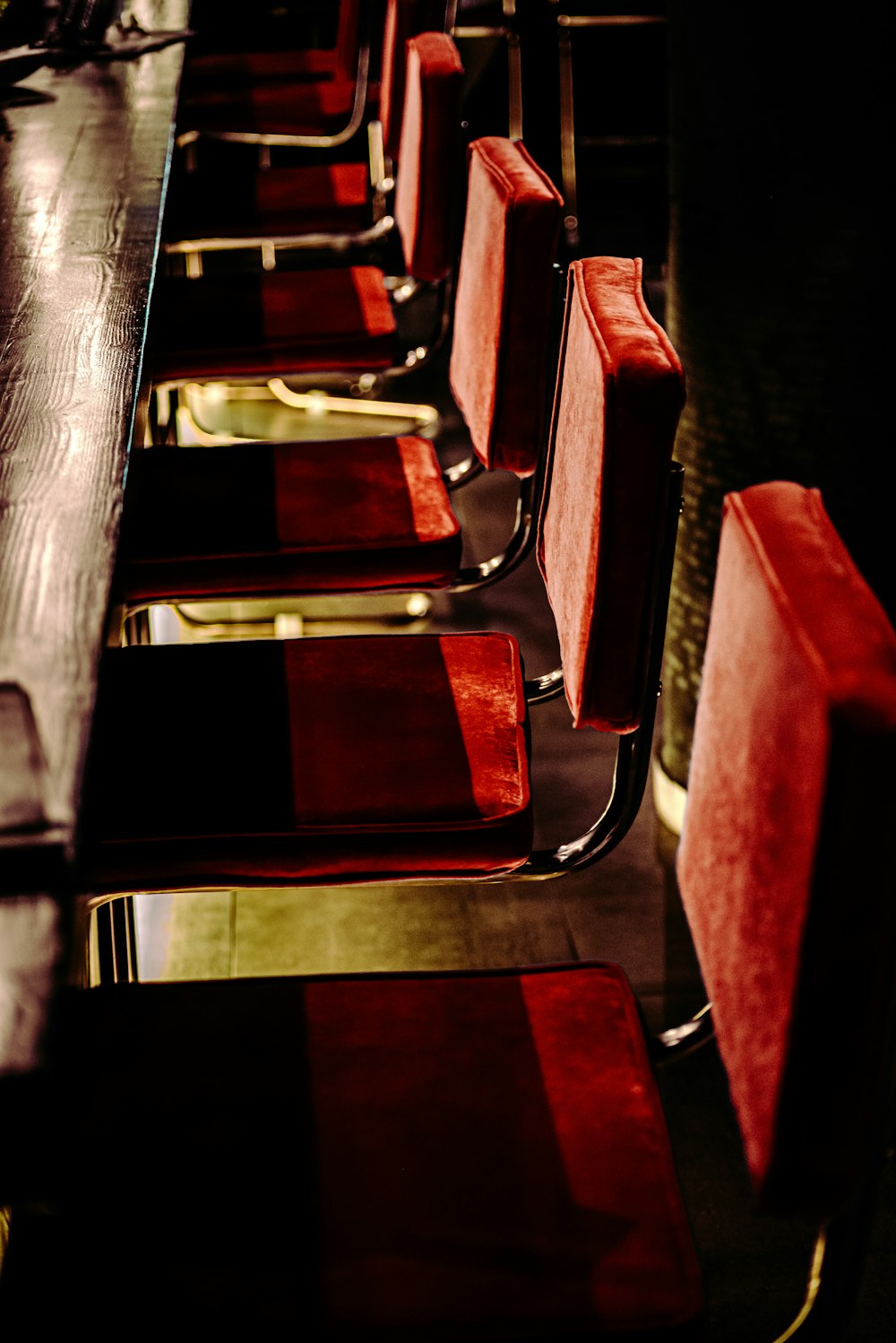 brown wooden chair with red cushion