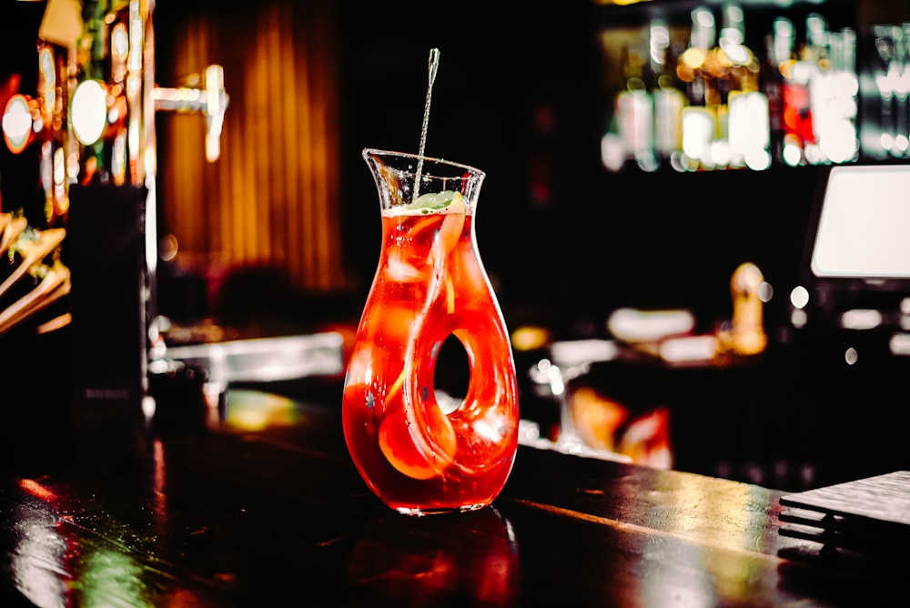 clear drinking glass with orange liquid