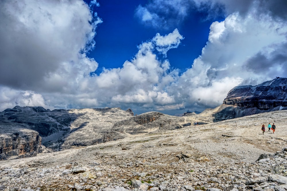 white clouds over brown mountain